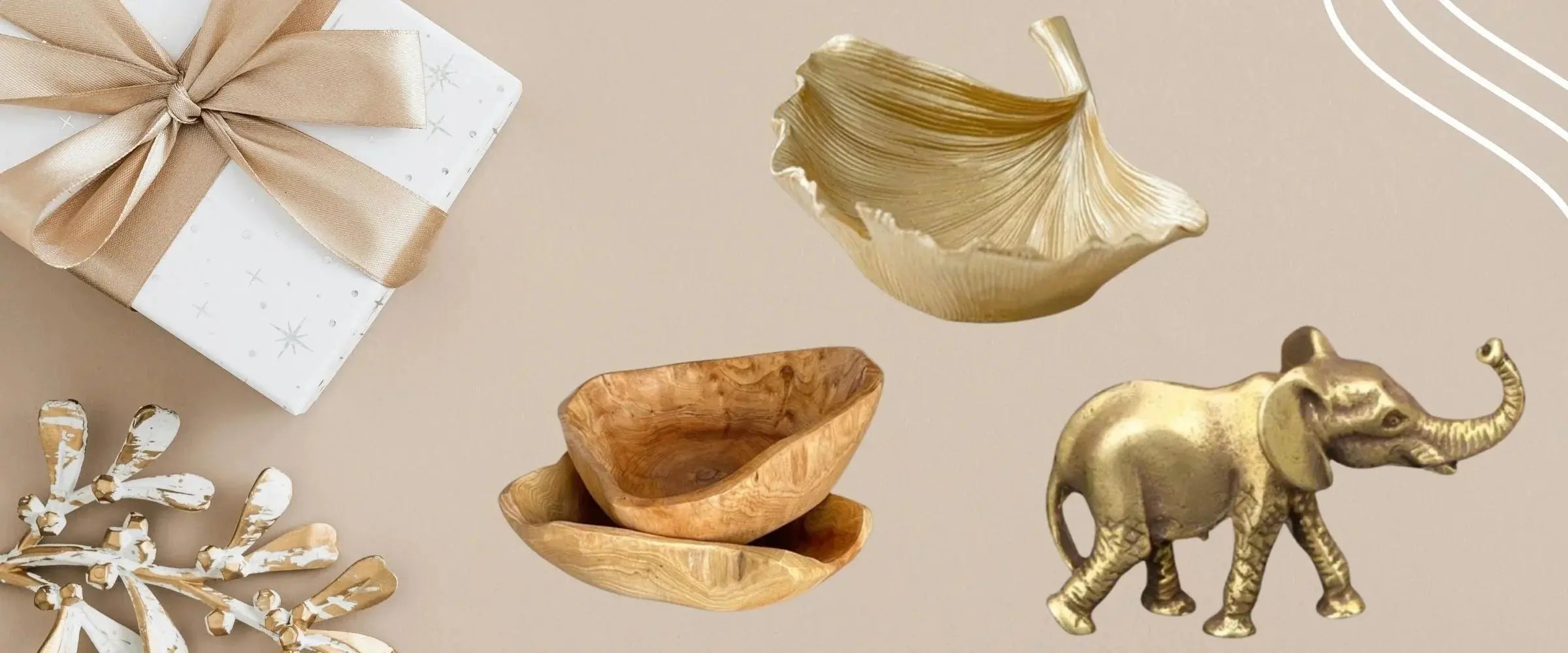 Decorative wooden bowls, brass elephant figurine, gold leaf dish and wrapped gift box on beige background