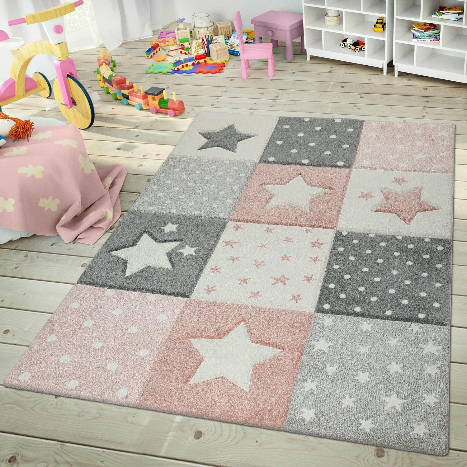 Kids bedroom with soft star-patterned and polka dot rug in pink, gray, and white on wooden floor
