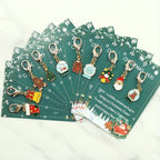 10 Christmas Themed Keychains, with Designs of Santa Claus, Snowman, Gingerbread Man, Bells, Reindeer, Etc., with Christmas Hug Greeting Card Blessings. This Is a Small Christmas Hug, Suitable As a Holiday Gift for Relatives House Of Avana