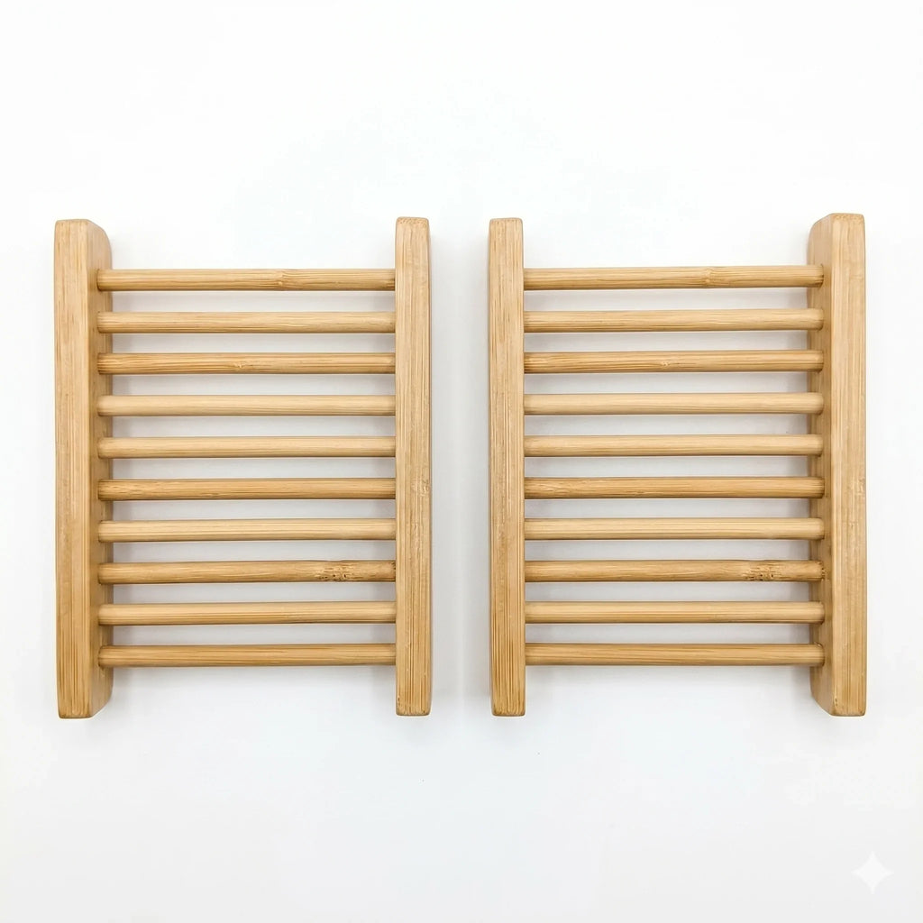 Two rectangular natural bamboo soap dishes with slatted drainage design on a white background.