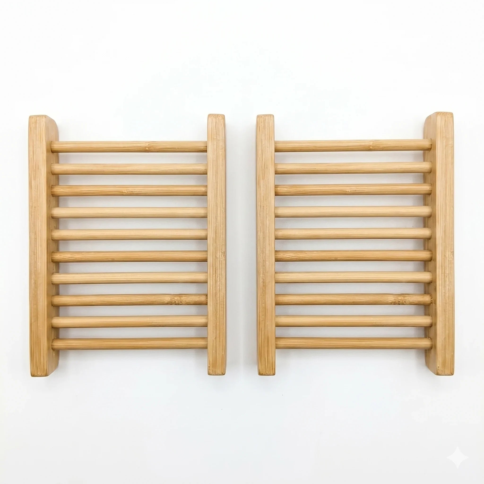 Two rectangular natural bamboo soap dishes with slatted drainage design on a white background.