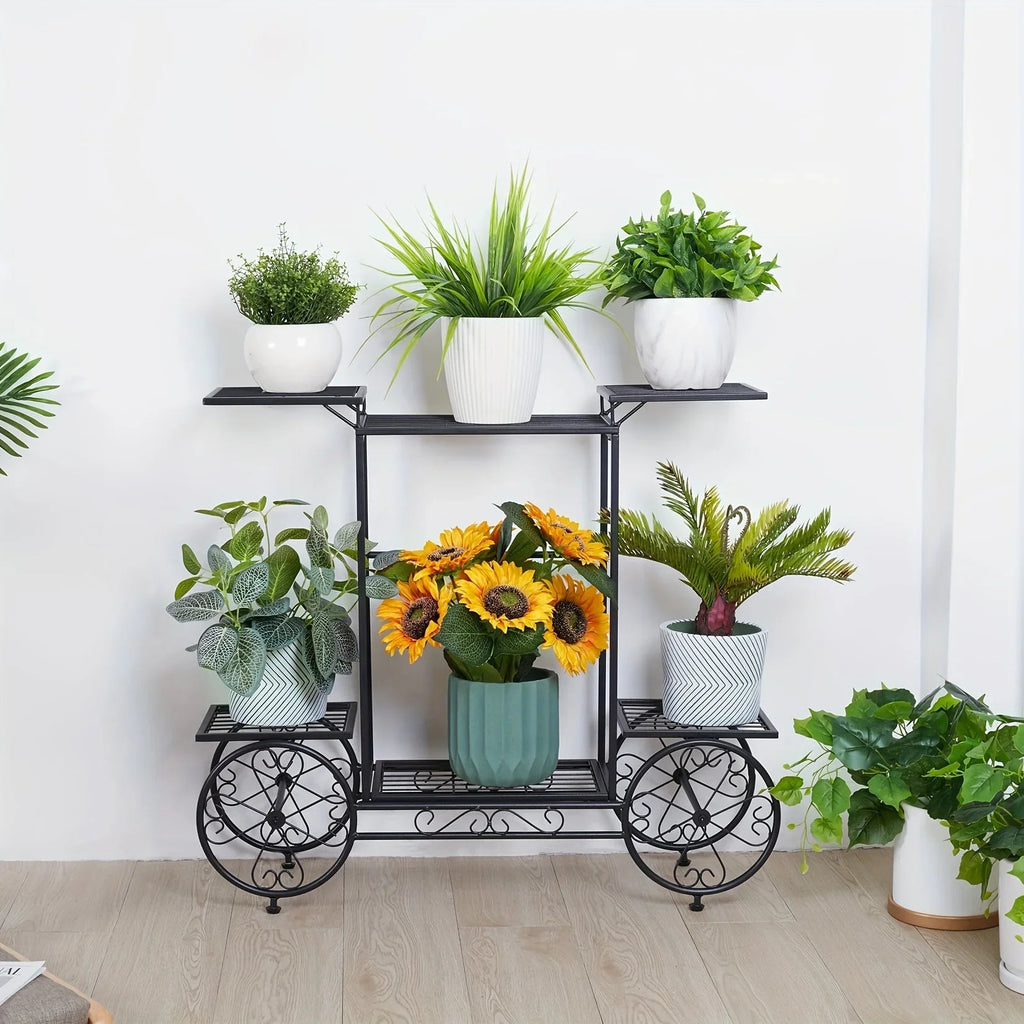 Black 6-tier metal garden cart plant stand with iron scrollwork holding various potted plants. [[SKU:HOA-GDN-011]]