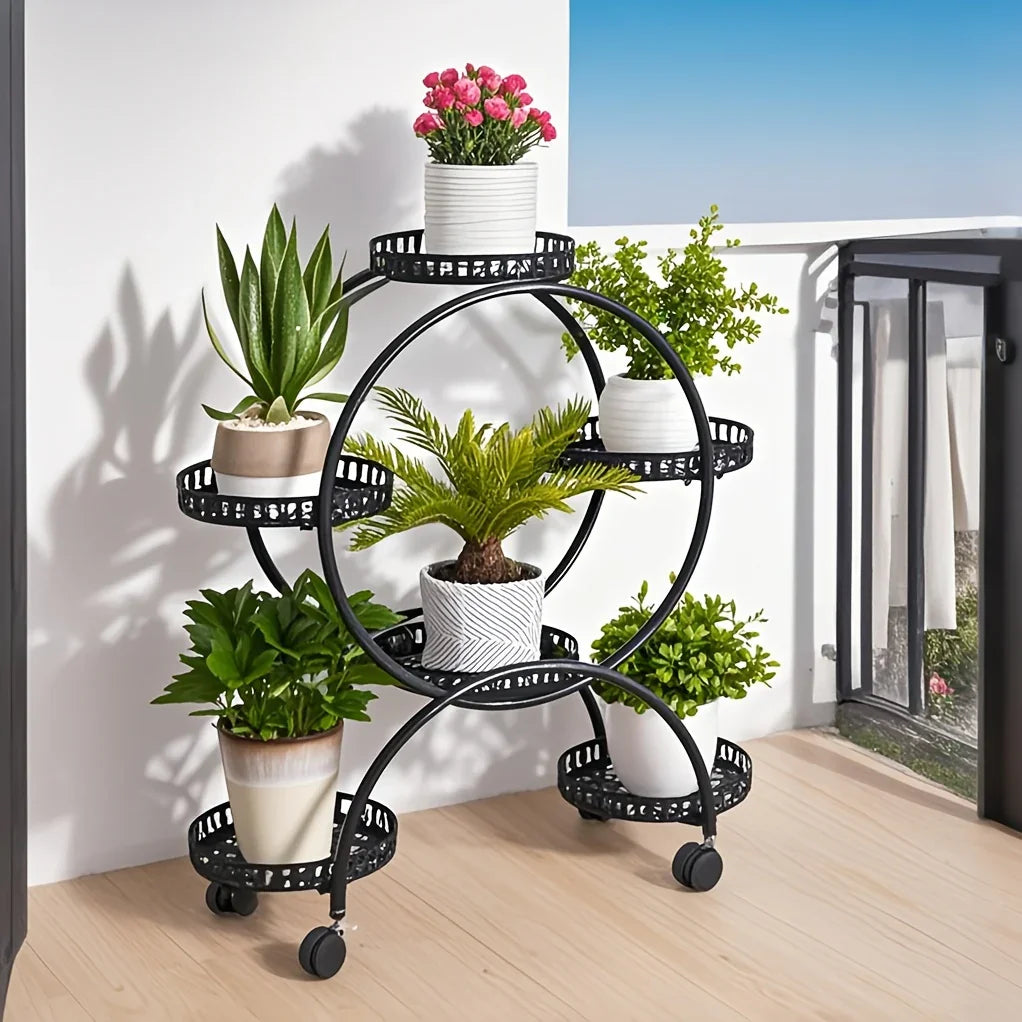 Black 6-tier wrought iron metal plant stand garden cart with wheels on a balcony holding potted plants. [[SKU:HOA-GDN-010]]