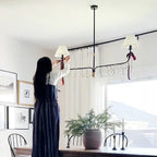 61 Inch Two Shade Linear Iron Pendant, angled view - House Of Avana