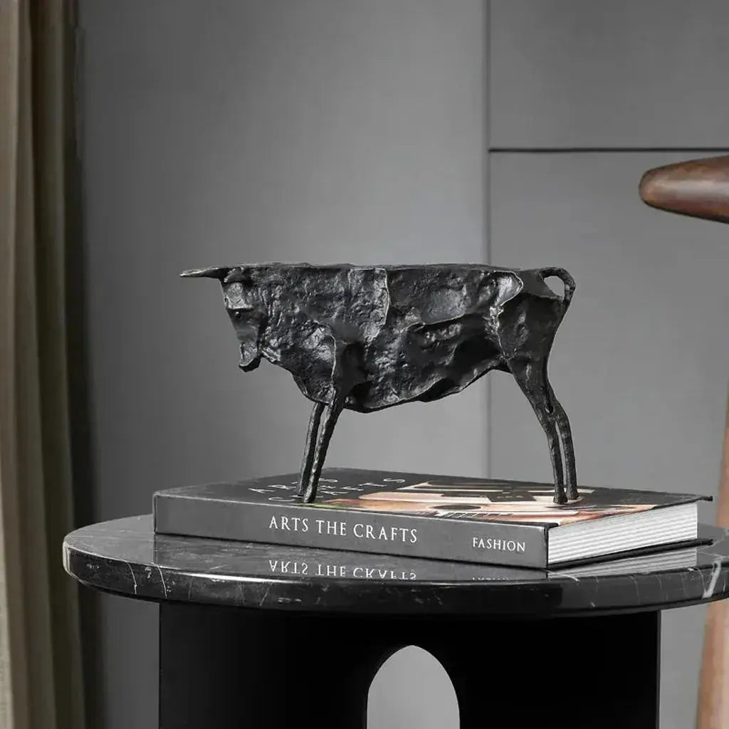 Black textured metal bull statue with metallic finish for modern home decor and abstract art collection