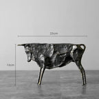 Dark textured metal bull statue with rustic metallic finish for unique home decor and artistic display