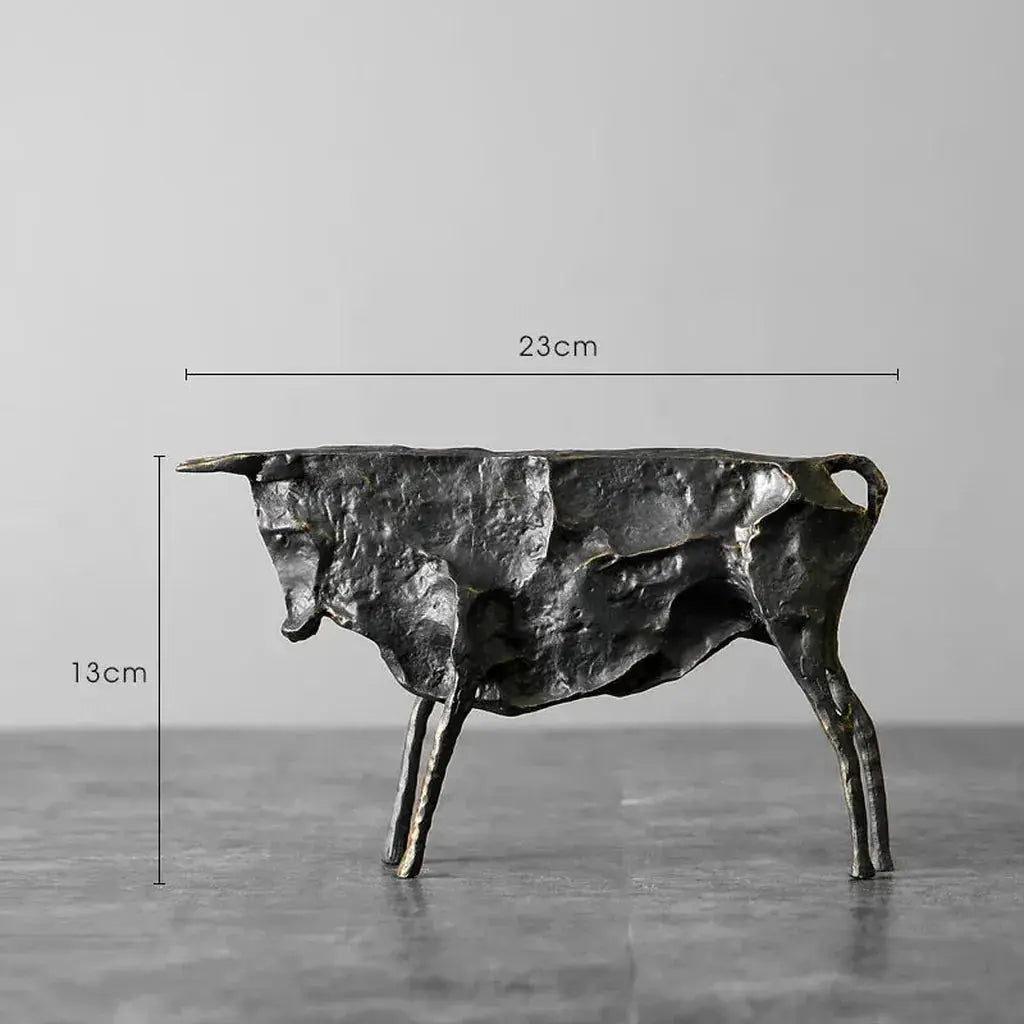 Dark textured metal bull statue with rustic metallic finish for unique home decor and artistic display