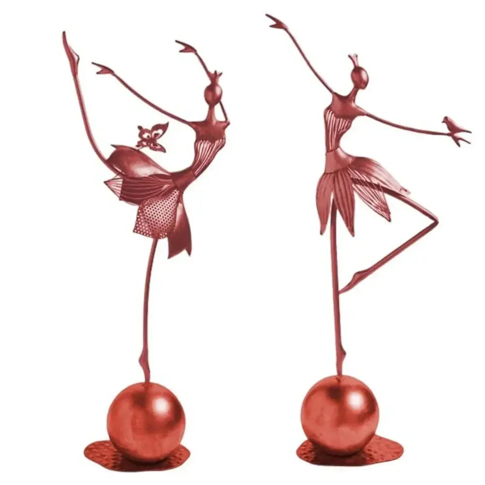 Two rose-gold abstract dancing ballerina metal sculptures on polished spherical bases, one balancing and one with a bird