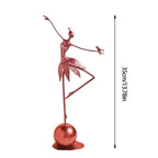 Rose-gold abstract dancing ballerina metal sculpture balancing on one leg with a bird on her arm atop a spherical base