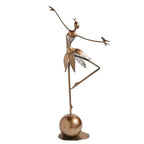 Bronze abstract dancing ballerina metal sculpture with delicate leaf-like skirt and small bird on outstretched arm