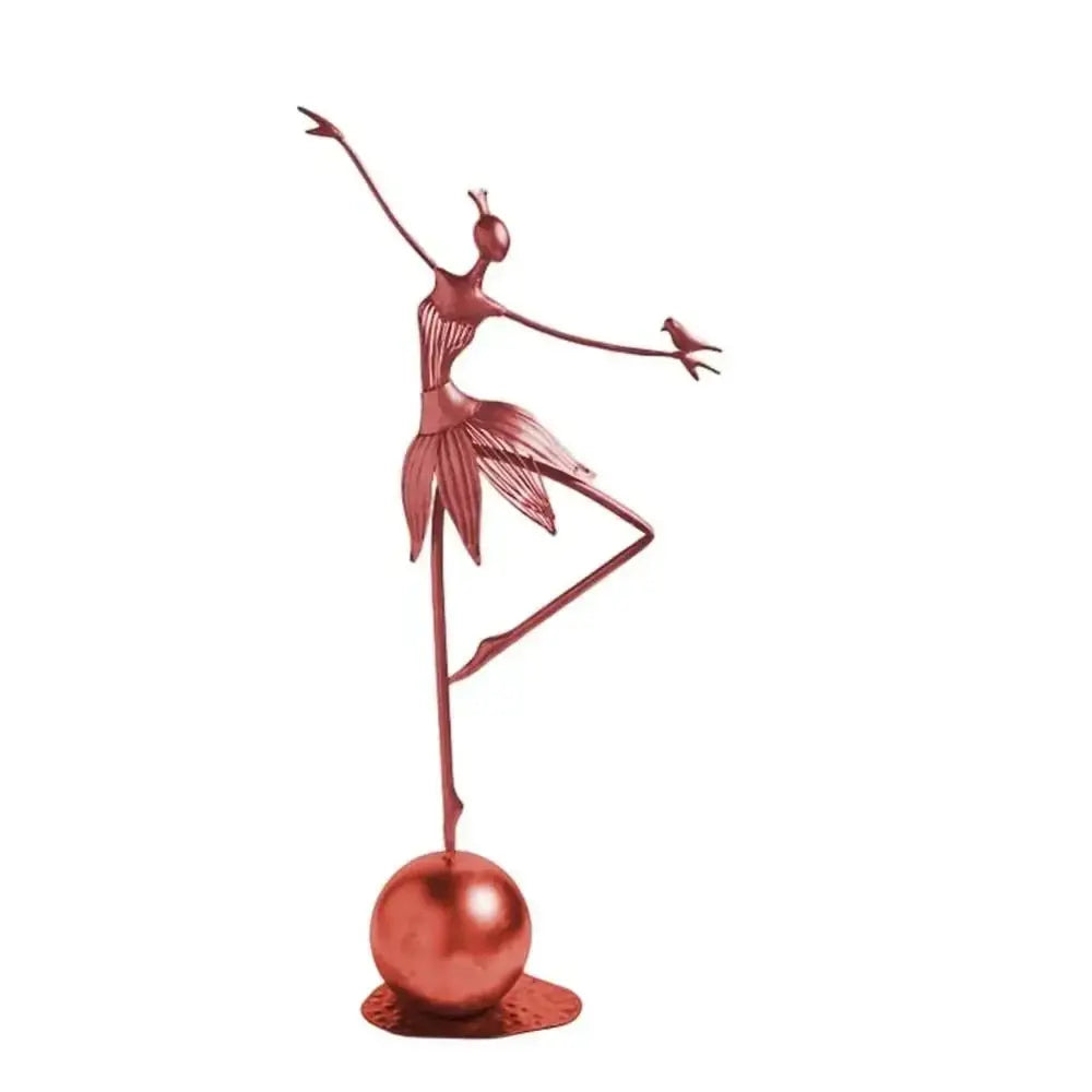 Rose-gold abstract dancing ballerina metal sculpture figurine balancing on one leg with a bird on her hand on a spherical base