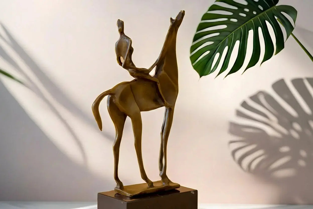Bronze-colored abstract horse rider sculpture mounted on a dark rectangular base decorative rider sculpture