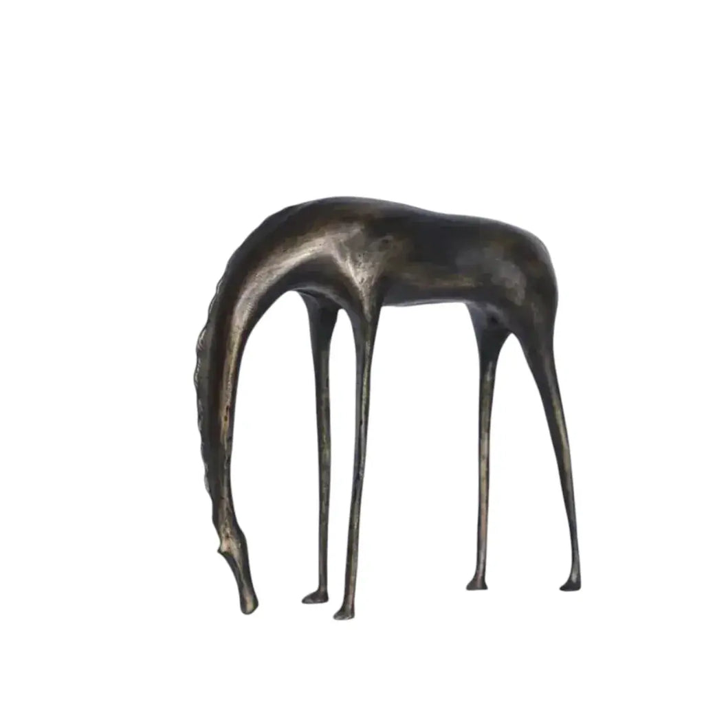 Abstract bronze giraffe sculpture with elongated legs and curved neck resembling an abstract grazing horse sculpture for decor