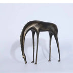 Bronze-colored abstract giraffe sculpture with slender legs and elongated neck for rustic living room decor