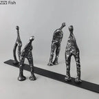 Set of four abstract metal figures in dark silver cast iron with textured minimalist human forms on a black base