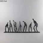 Set of seven abstract metal figures in varying poses on a sleek black cast iron base sculpture