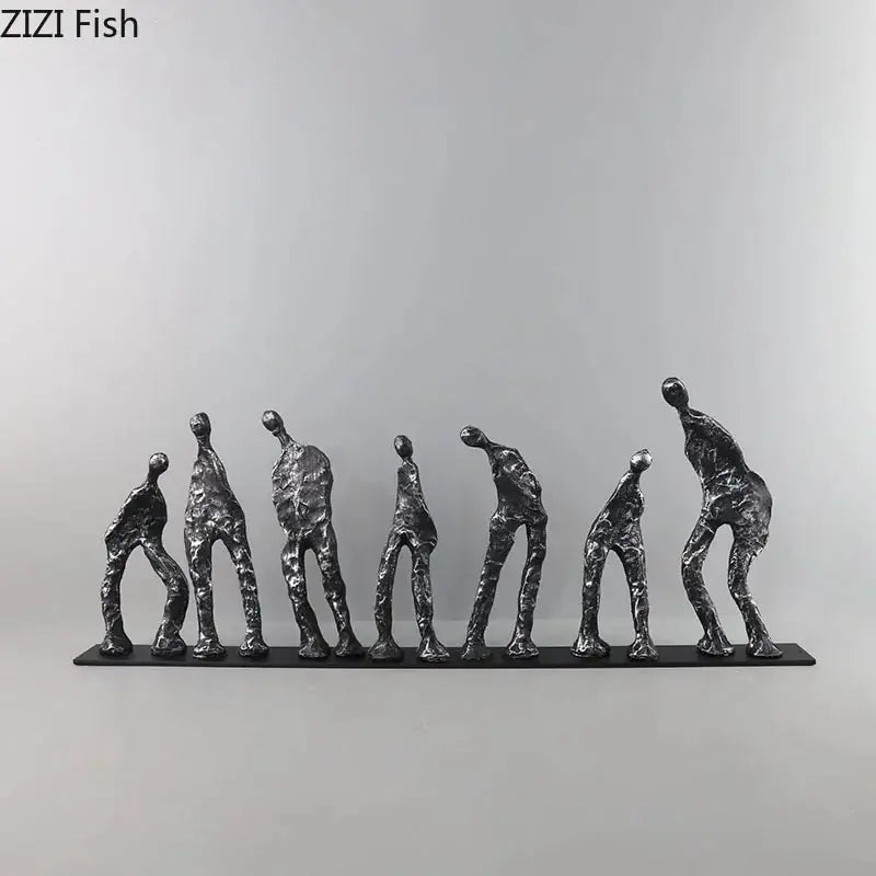 Set of seven abstract metal figures in varying poses on a sleek black cast iron base sculpture