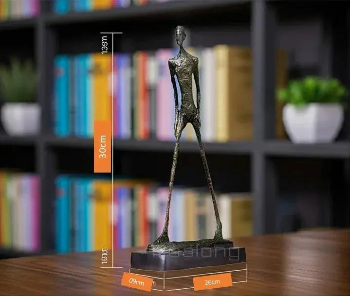 Bronze-colored abstract walking man sculpture with elongated limbs and textured metal surface on dark base