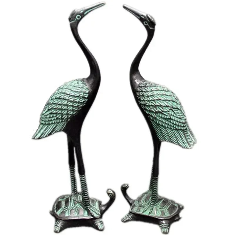 Bronze-colored antique crane figurines with green patina standing on turtle statue set bases for luxury decor