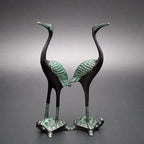 Two elegant bronze antique crane figurines standing on green patina turtle statue bases for luxury home decor