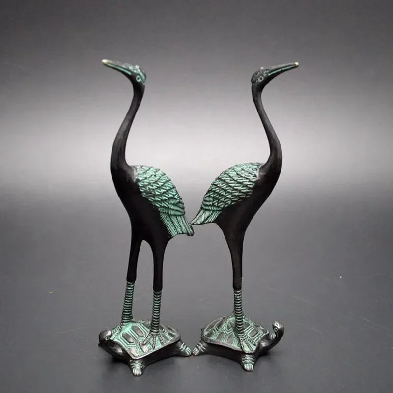 Two elegant bronze antique crane figurines standing on green patina turtle statue bases for luxury home decor