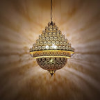 Ornate chandelier with intricate design on a warm beige background