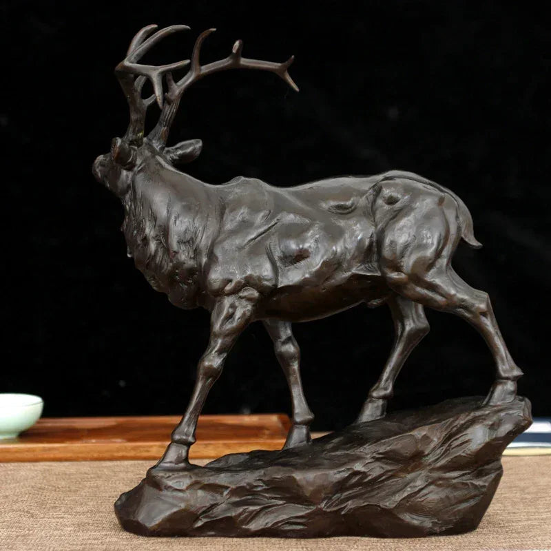 Bronze deer buck decorative sculpture with detailed antlers and textured body on rocky base for living rooms