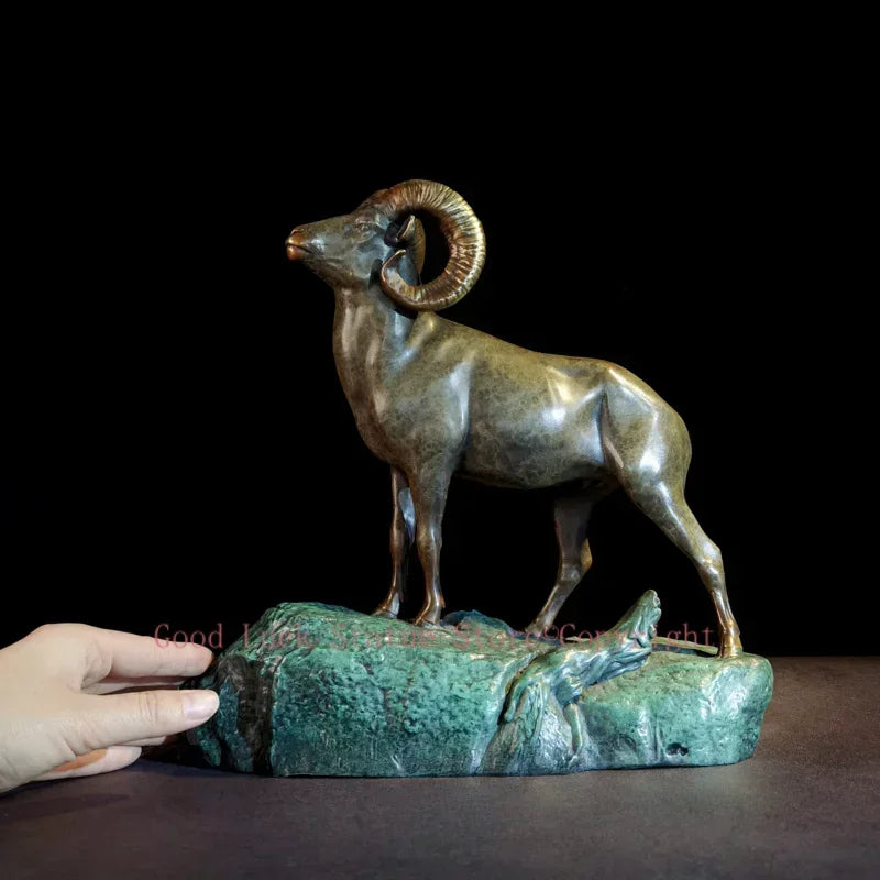 Bronze ram decorative sculpture with detailed curved horns on a textured rocky base for living room tabletop decor
