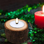 A wooden mini candle holder with natural bark texture and light inner ring holding a lit tealight candle