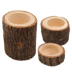 Three rustic wooden mini candle holders with natural bark exterior and smooth inner surface for candles