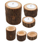 Set of rustic wooden mini candle holders with natural bark texture holding white tea light candles