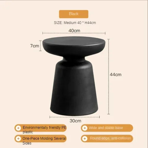 Black compact size coffee table for living room with sleek round top and wide base made of eco-friendly PE plastic