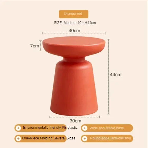 Orange-red coffee table stool with rounded top and wide base made of eco-friendly PE plastic for compact living room use