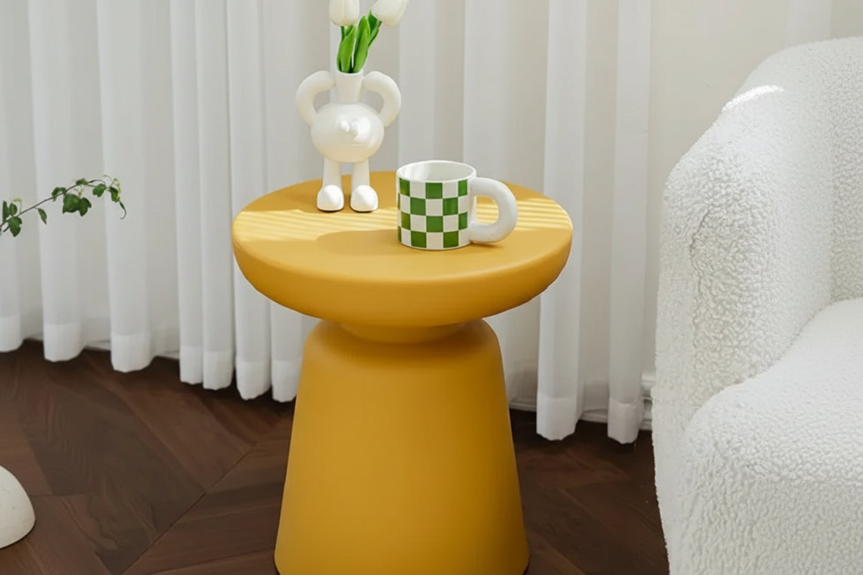 Yellow round coffee table with compact size wooden top and tapered legs for living room use