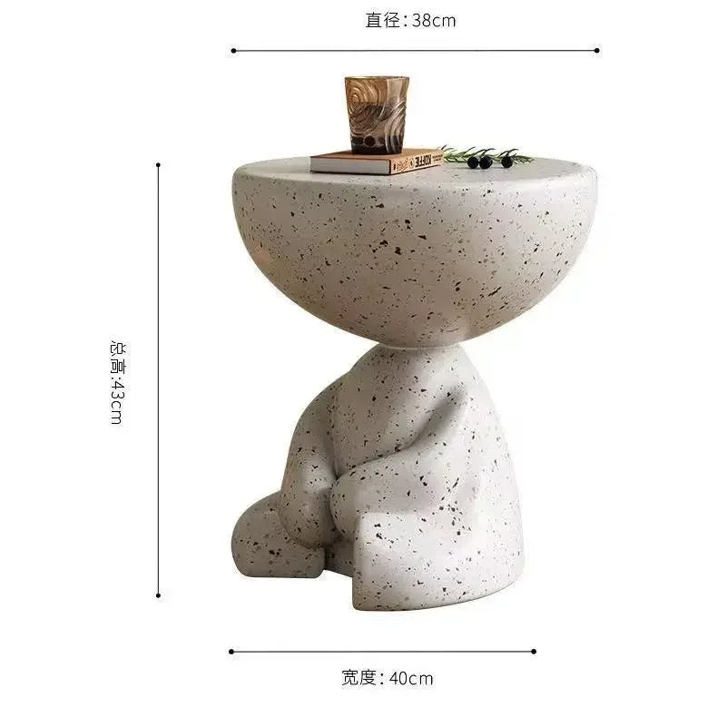 White speckled marble small coffee table with rounded top and sculpted base for living room use