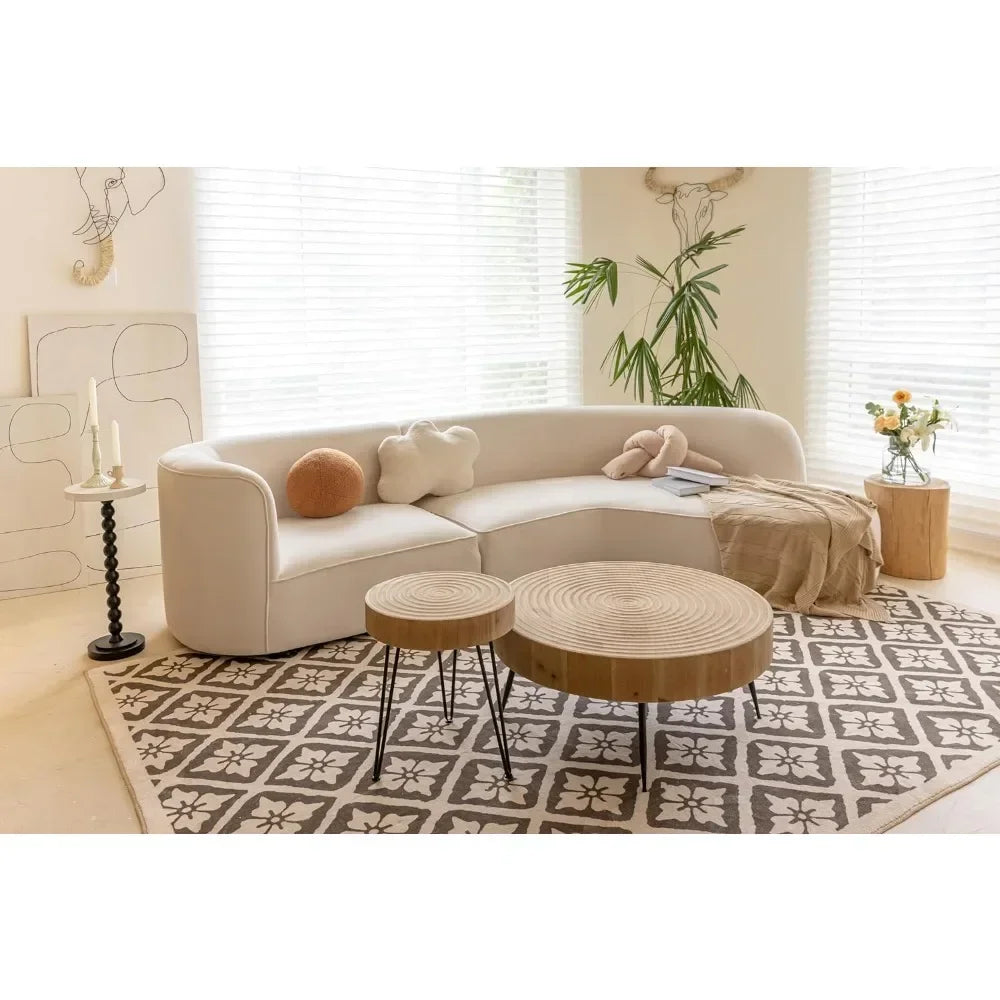 Rustic wooden rectangular coffee table beside a cream-colored curved sectional sofa with plush cushions in living room