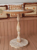 Coffee table small round wooden with a glass top and ornate carved base in natural wood finish
