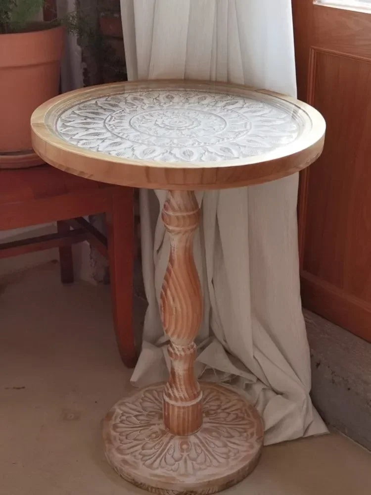 Coffee table small round wooden with intricately carved light-toned top and twisted pedestal base for living room use