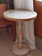 Coffee table small round wooden with intricately carved light-toned top and twisted pedestal base for living room use