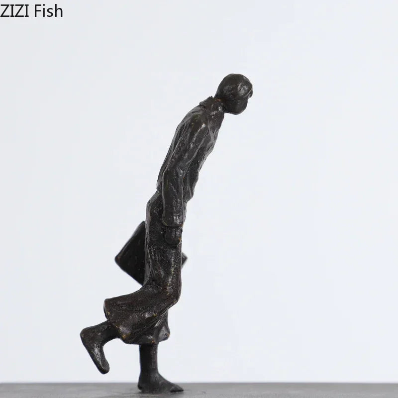Dark bronze metal dancer statue of a man in mid-stride with coat and briefcase perfect for art lovers and ballet enthusiasts