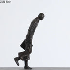 Dark bronze metal dancer statue of a man in mid-stride with coat and briefcase perfect for art lovers and ballet enthusiasts