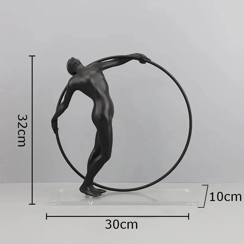 Black matte metal desk statue of a nude male figure holding a circular hoop for modern home office decor