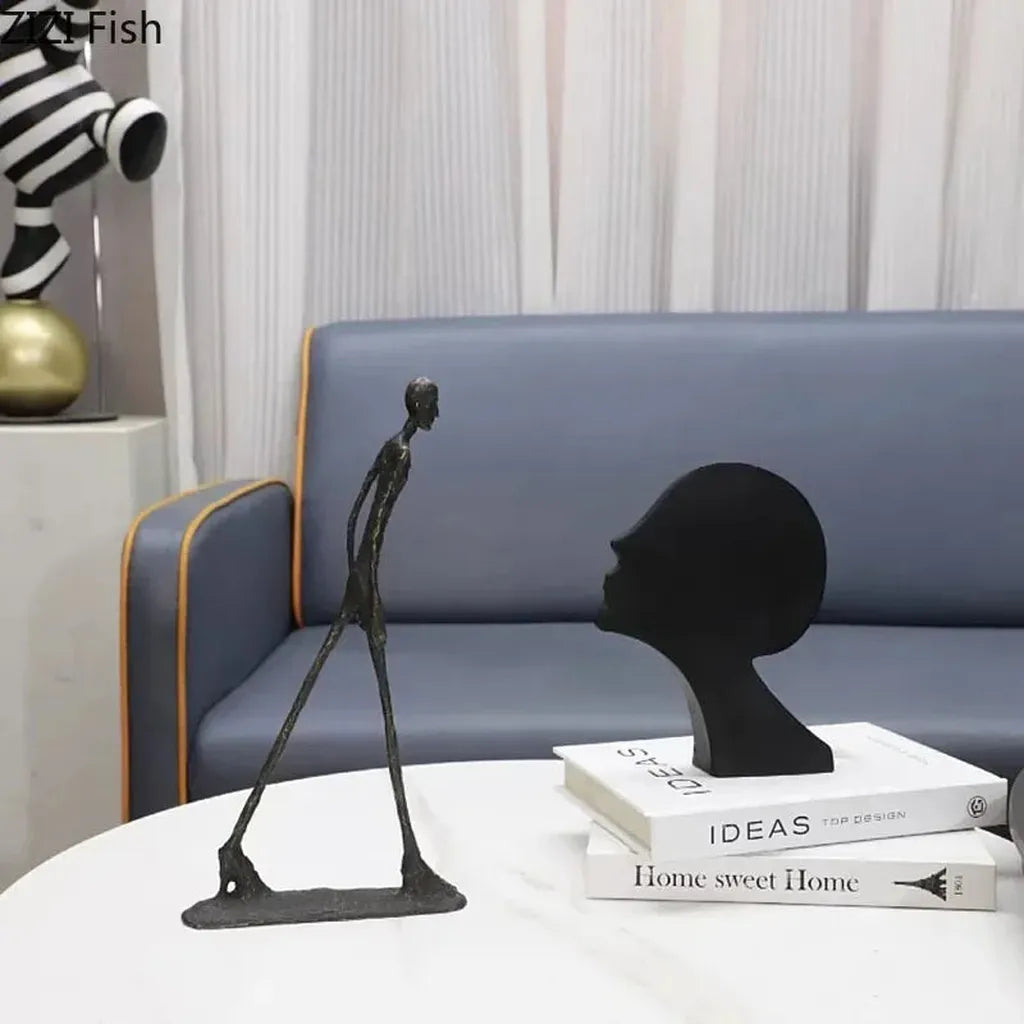 Black matte modern design desk statue in cast metal featuring abstract walking figure and profile head for home office