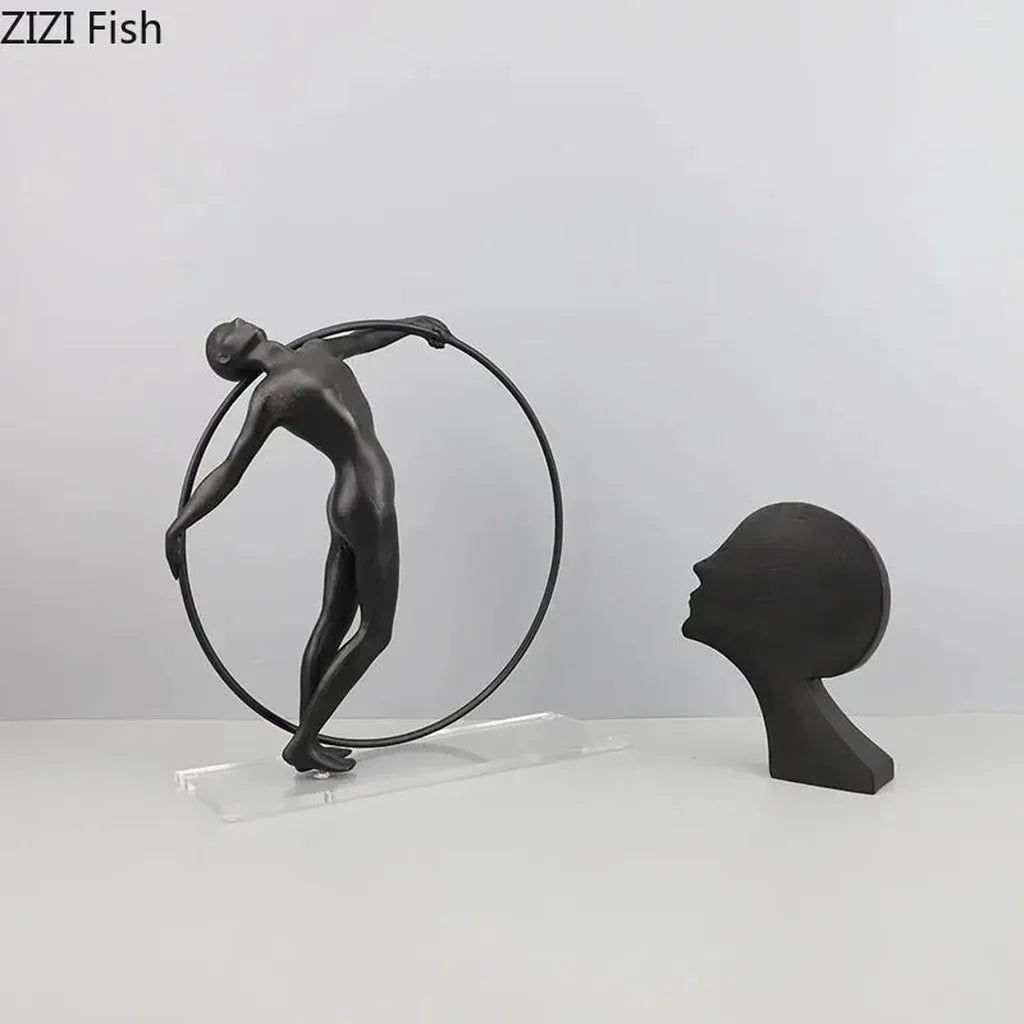 Black matte desk statue of a dancer balancing on a hoop modern design metal sculpture for home office decor