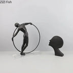 Black matte desk statue of a dancer balancing on a hoop modern design metal sculpture for home office decor