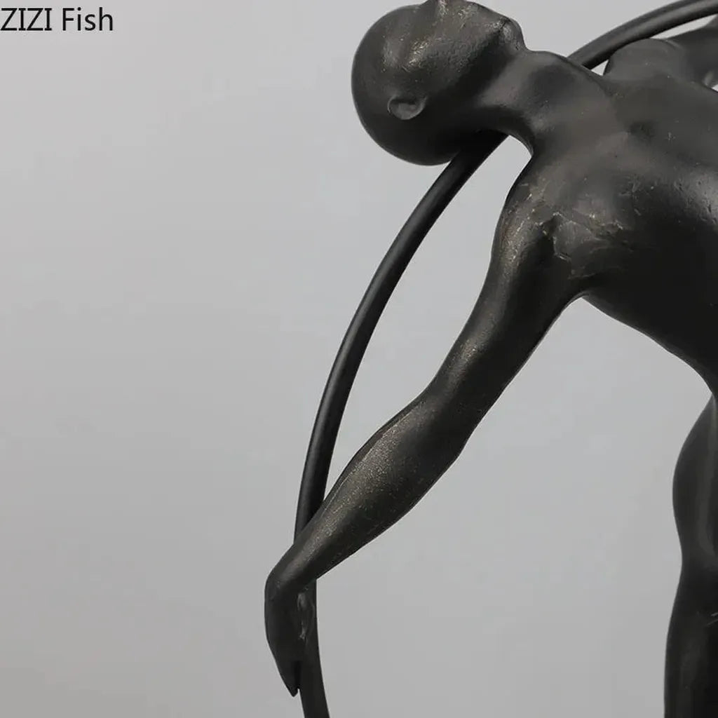 Black metallic desk statue featuring a stylized human figure with smooth contours for modern home office decor