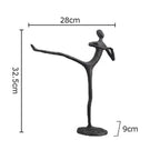 Black metal desk statue of a dancer in an elegant pose with modern design ideal for home office decor