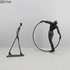 Black metal desk statue of a figure holding a circular hoop with modern design for home office decor