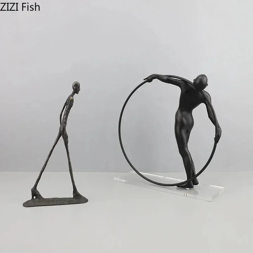 Black metal desk statue of a figure holding a circular hoop with modern design for home office decor