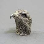 Silver eagle head figurine with detailed feather texture and polished beak in a decorative bronze eagle sculpture